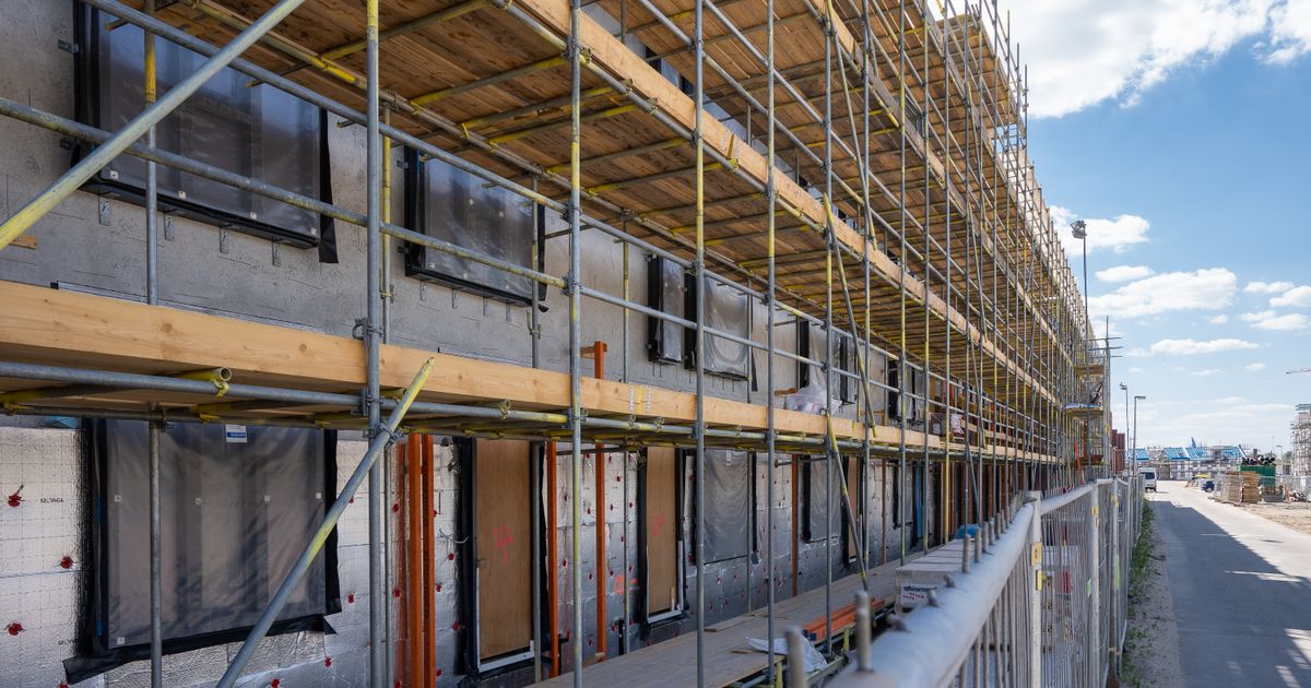 Scaffolding at a city construction site with clear blue skies.