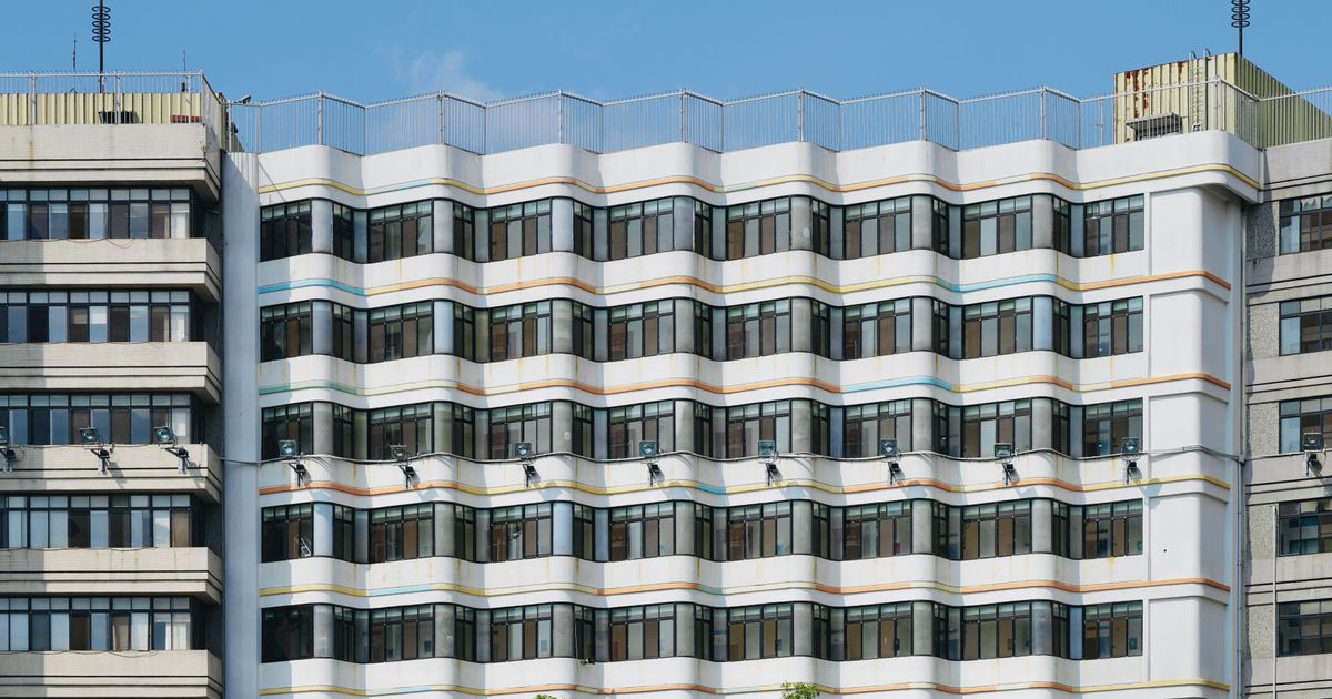 Contemporary building facade with distinctive geometric patterns, showcasing urban architectural design.