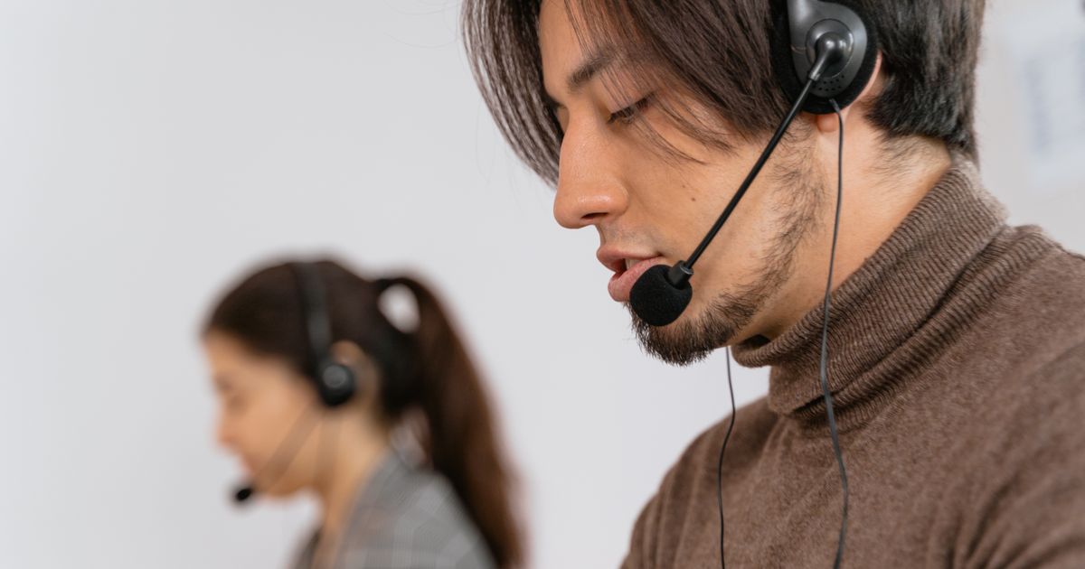 Focused call center employees wearing headsets, assisting customers with exceptional service.